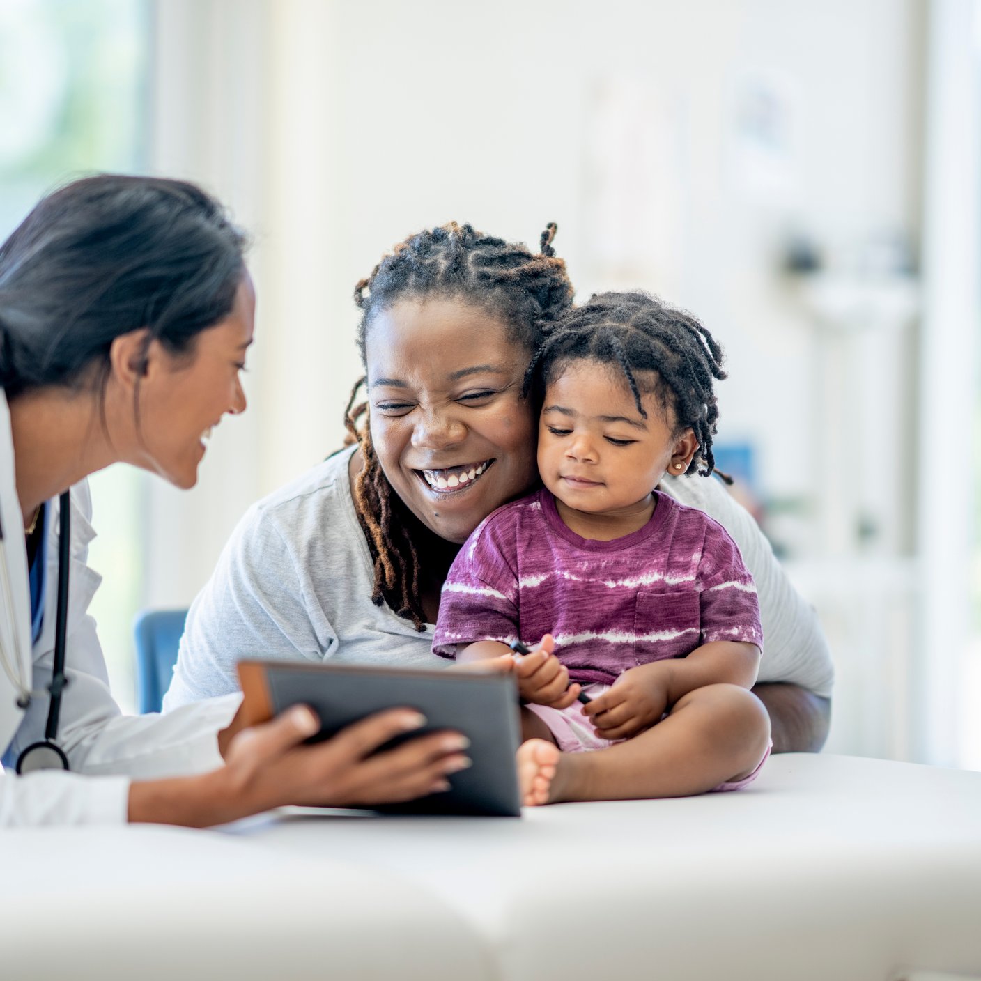 Young mother and her son visit the doctor together