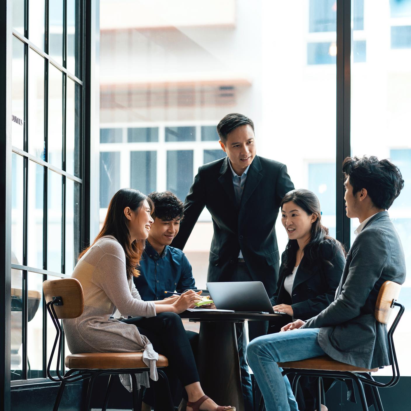 Creatives and team leader in discussion in an open working environment