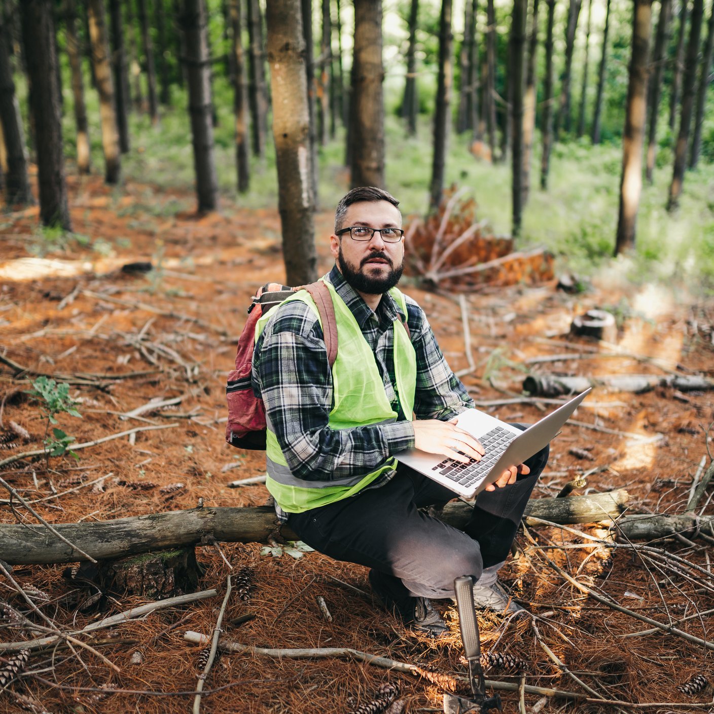 Construction worker sitting in the forest.