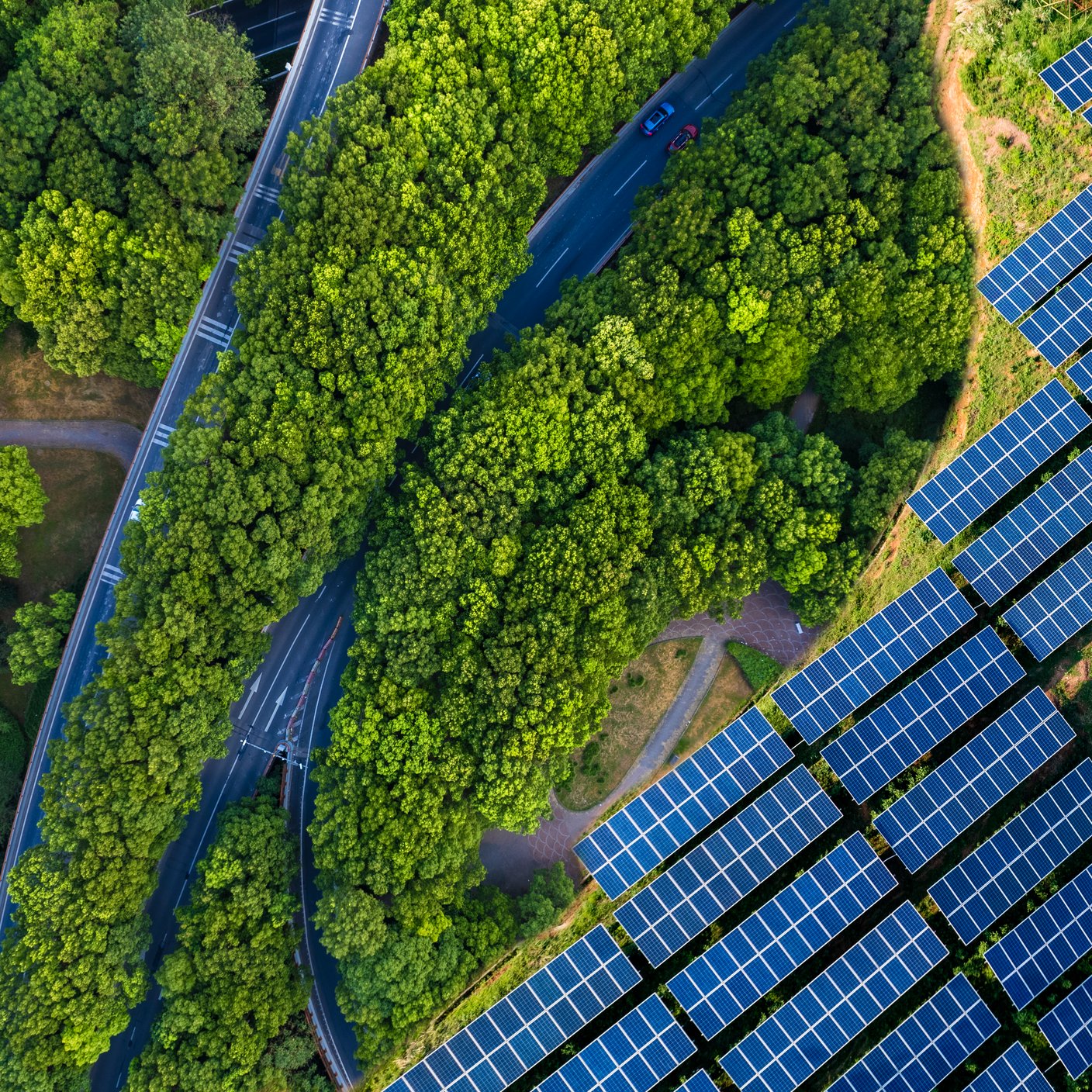 High angle view of Solar panels , agricultural landscape. Winding coastal road on turquoise coloured lake. Pudong, shanghai, China