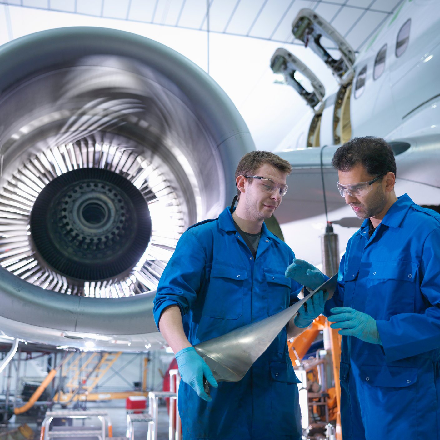 Two aviation engineers working in a factory