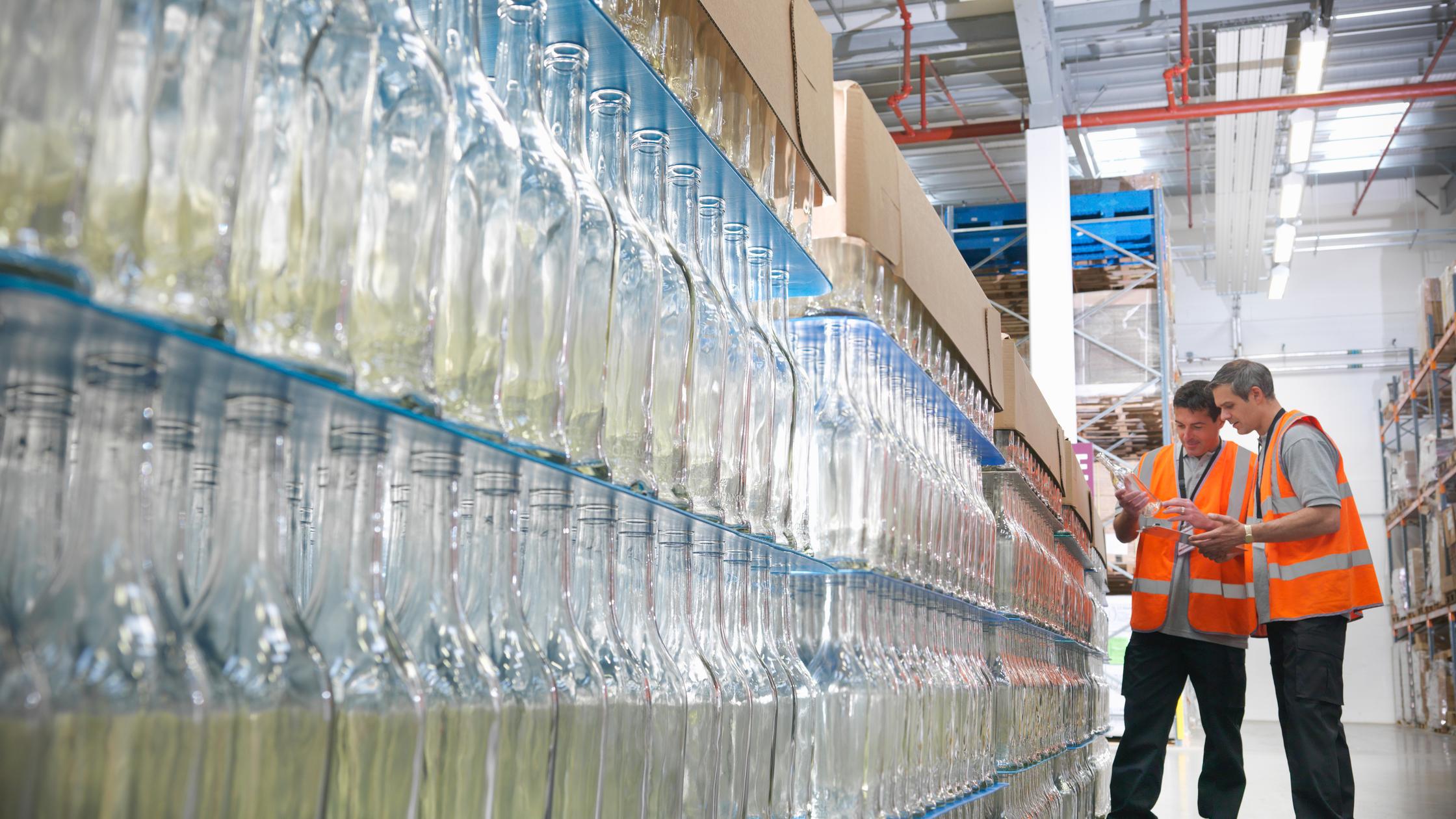 Factory workers examining bottles