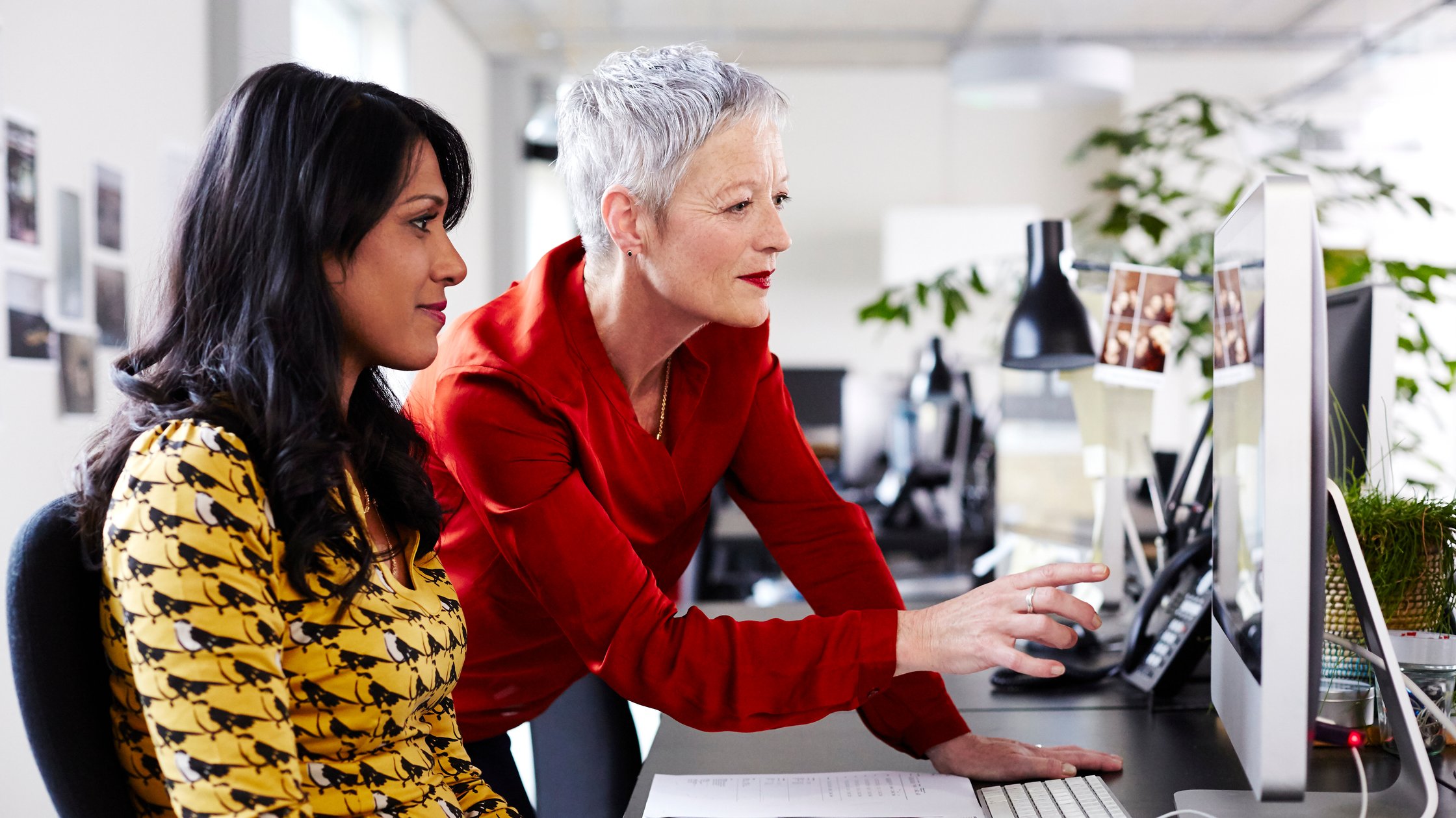 Mature business woman mentoring younger employee.